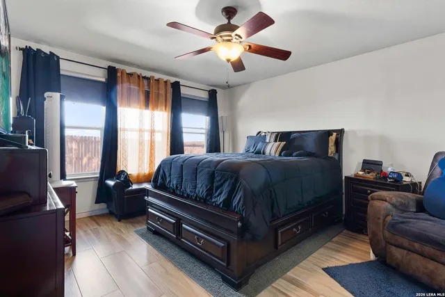 a bedroom with a bed couch and window