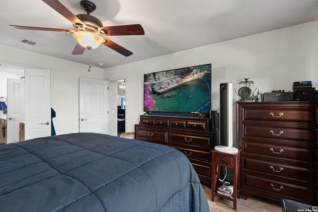 a bedroom with a bed and a flat screen tv