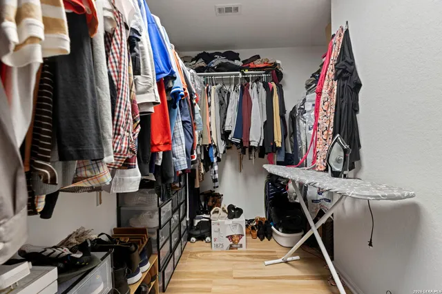 a view of walk in closet with clothes