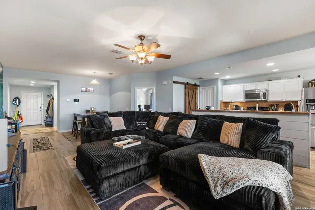 a living room with furniture and kitchen view