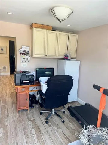 a view of a dining room with furniture a rug and wooden floor