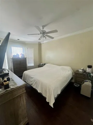 a bedroom with a bed window and wooden floor