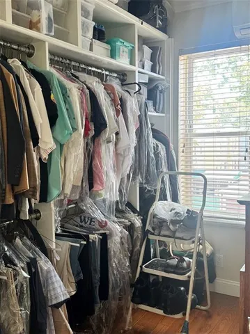 a bedroom with two bed and a window