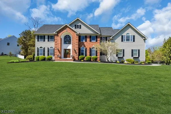 a front view of a house with a garden and yard