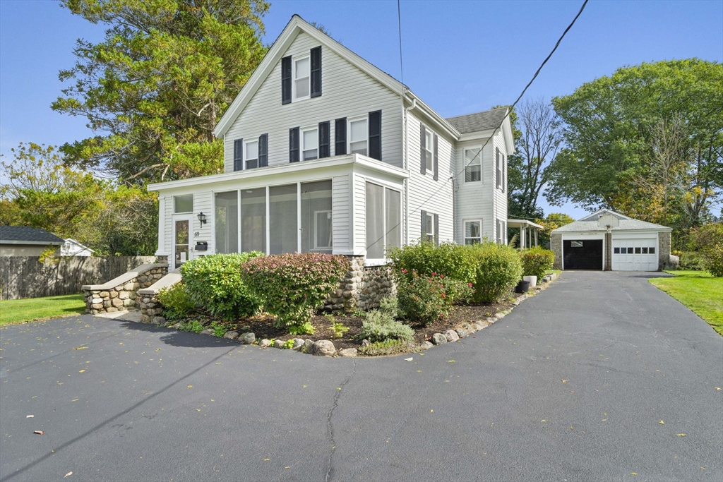 a front view of a house with a garden