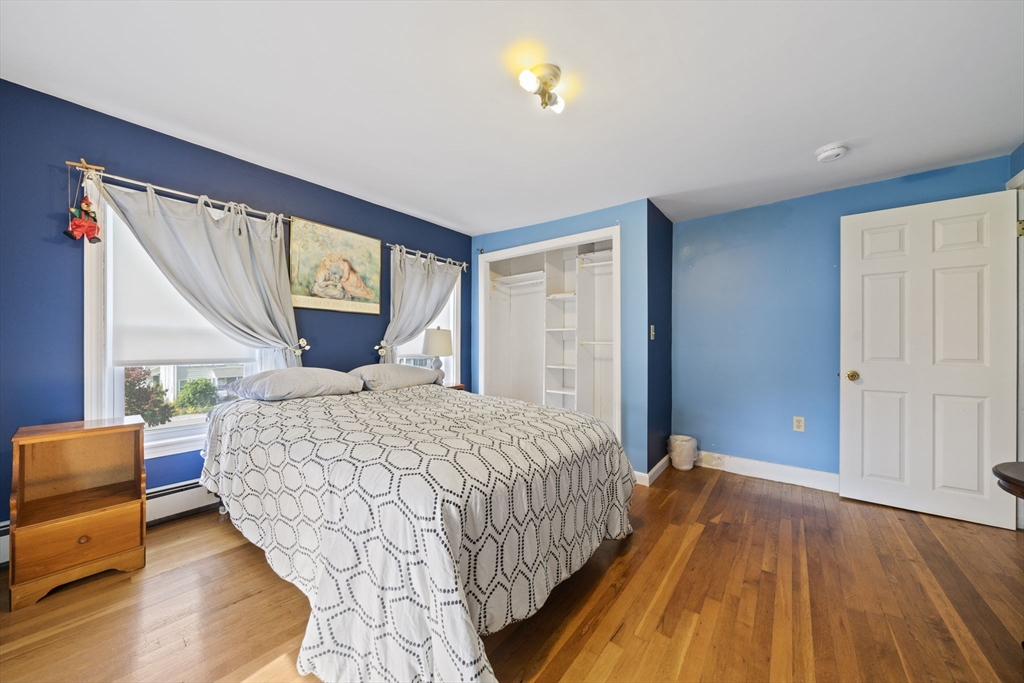 619 North Main Street Mansfield, MA 02048 - Photo 15 of 28 a bedroom with a bed and wooden floor