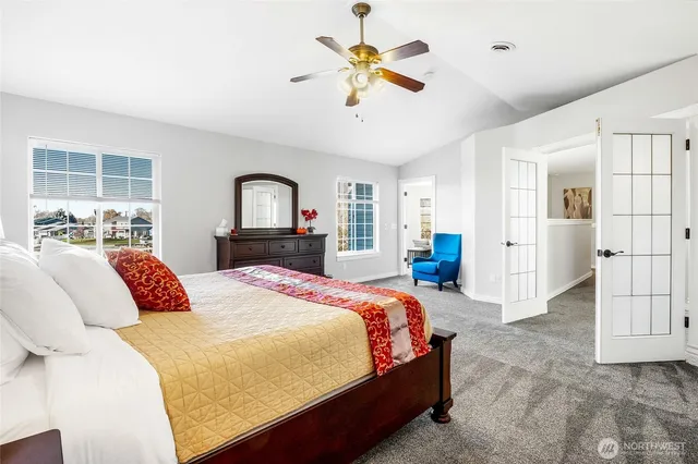 a bedroom with a bed and a chandelier