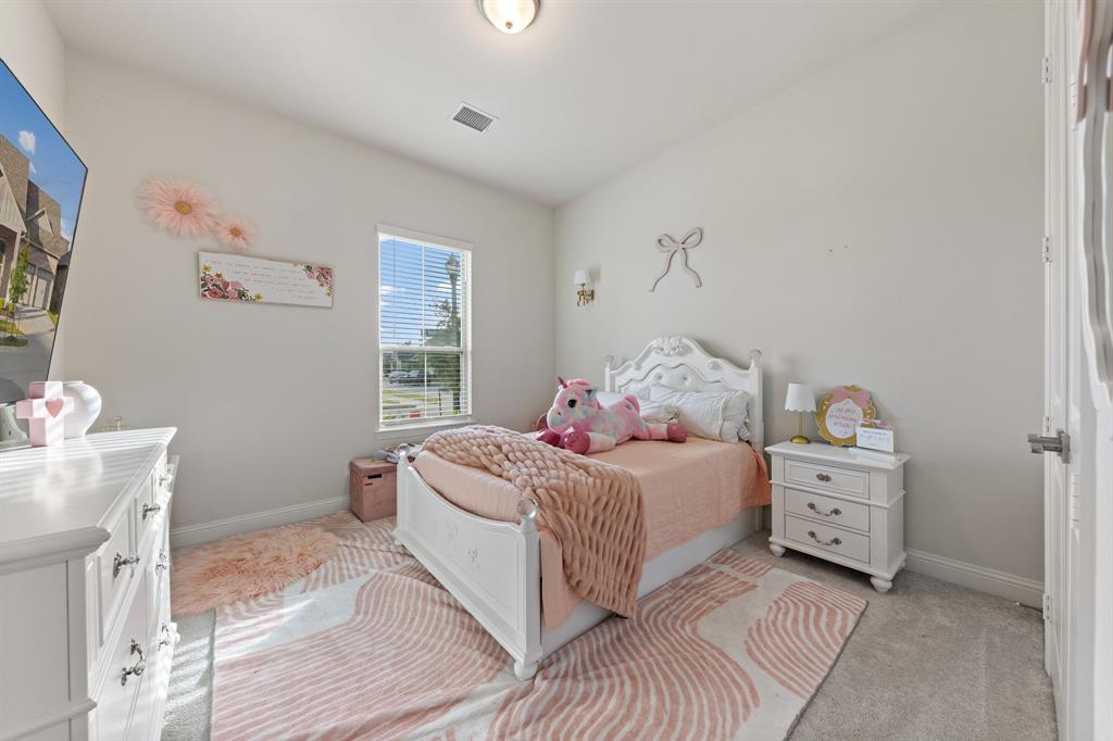 8808 Royal Star Road Rowlett, TX 75089 - Photo 29 of 40 a bedroom with a bed and a cabinets