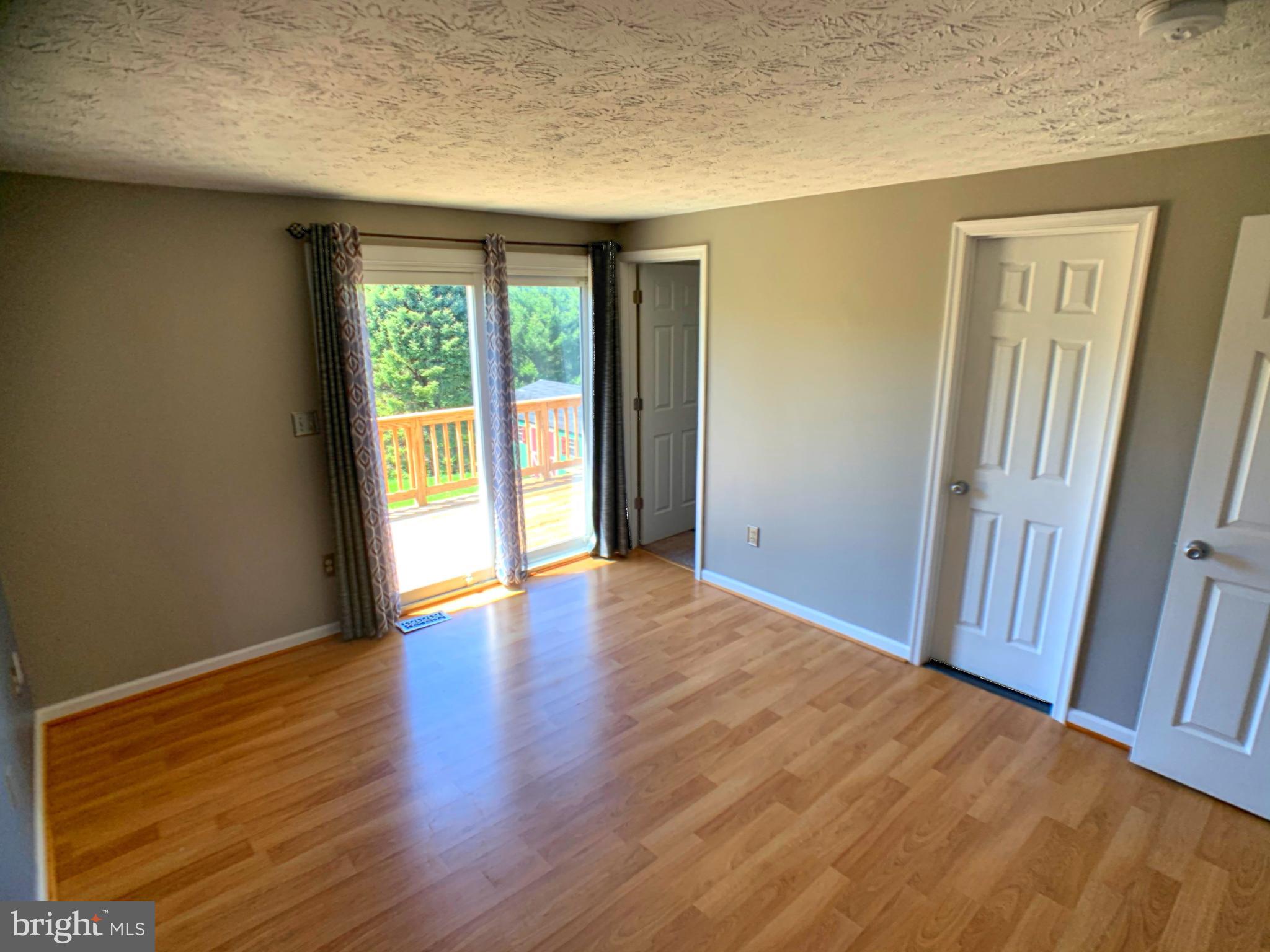 Master bedroom with exterior slider to deck