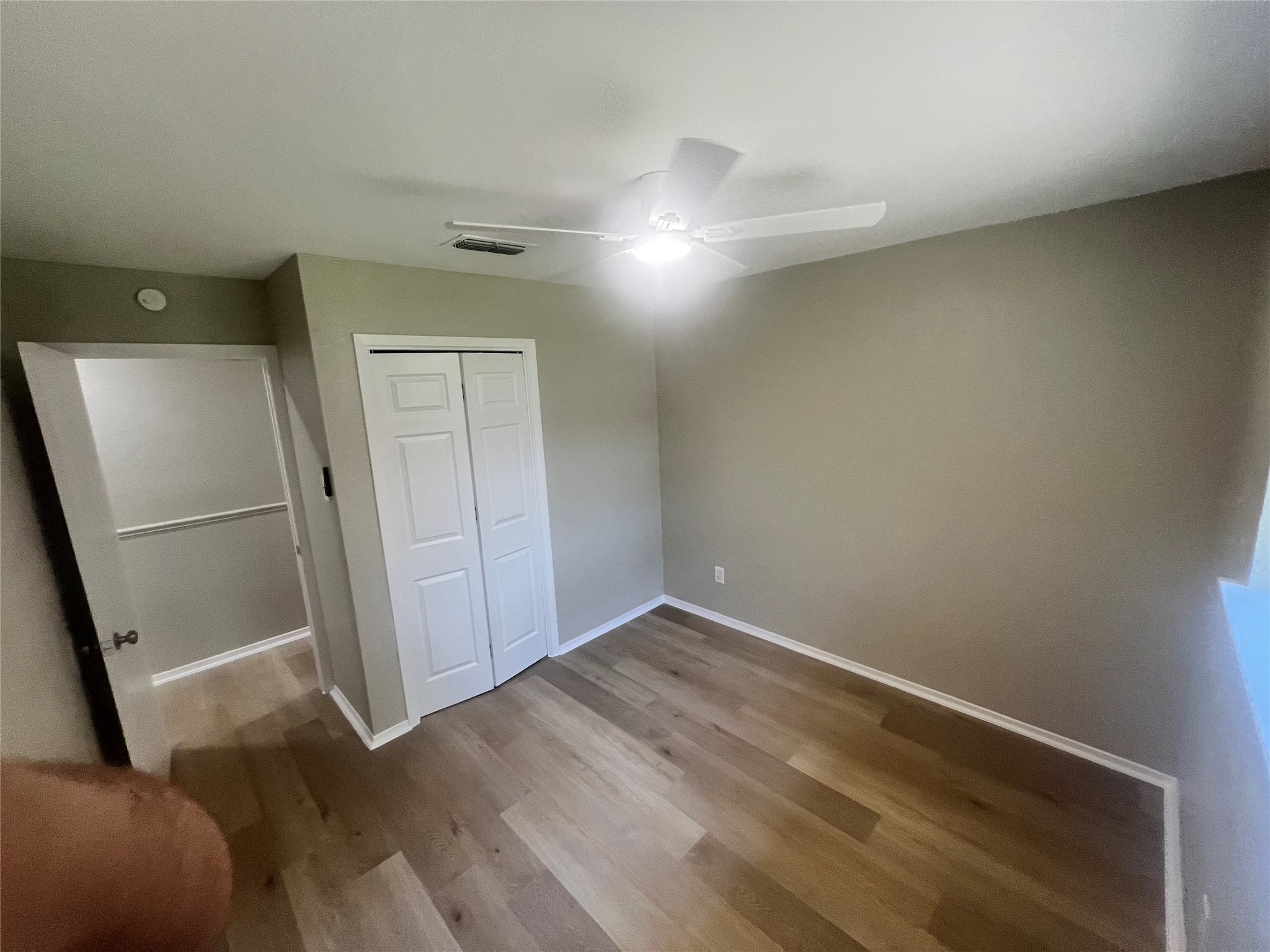 4620 Button Bend Road Austin, TX 78744 - Photo 13 of 22 Laminate flooring and a ceiling fan create a comfortable and functional living space.