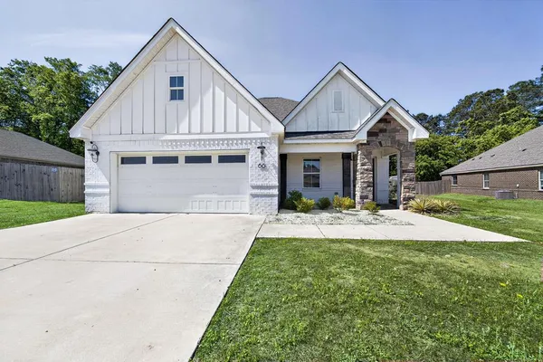 a front view of house with yard and green space