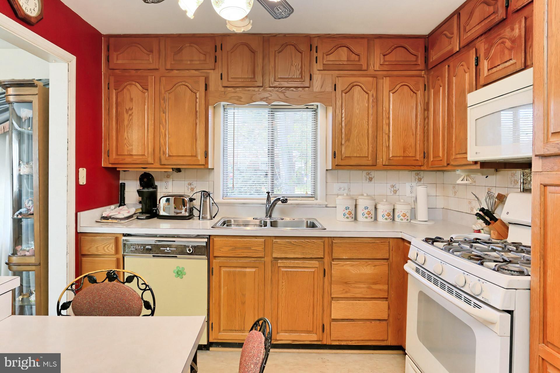 1806 Shenandoah Road Alexandria, VA 22308 - Photo 14 of 33 a kitchen with stainless steel appliances granite countertop a sink stove and cabinets