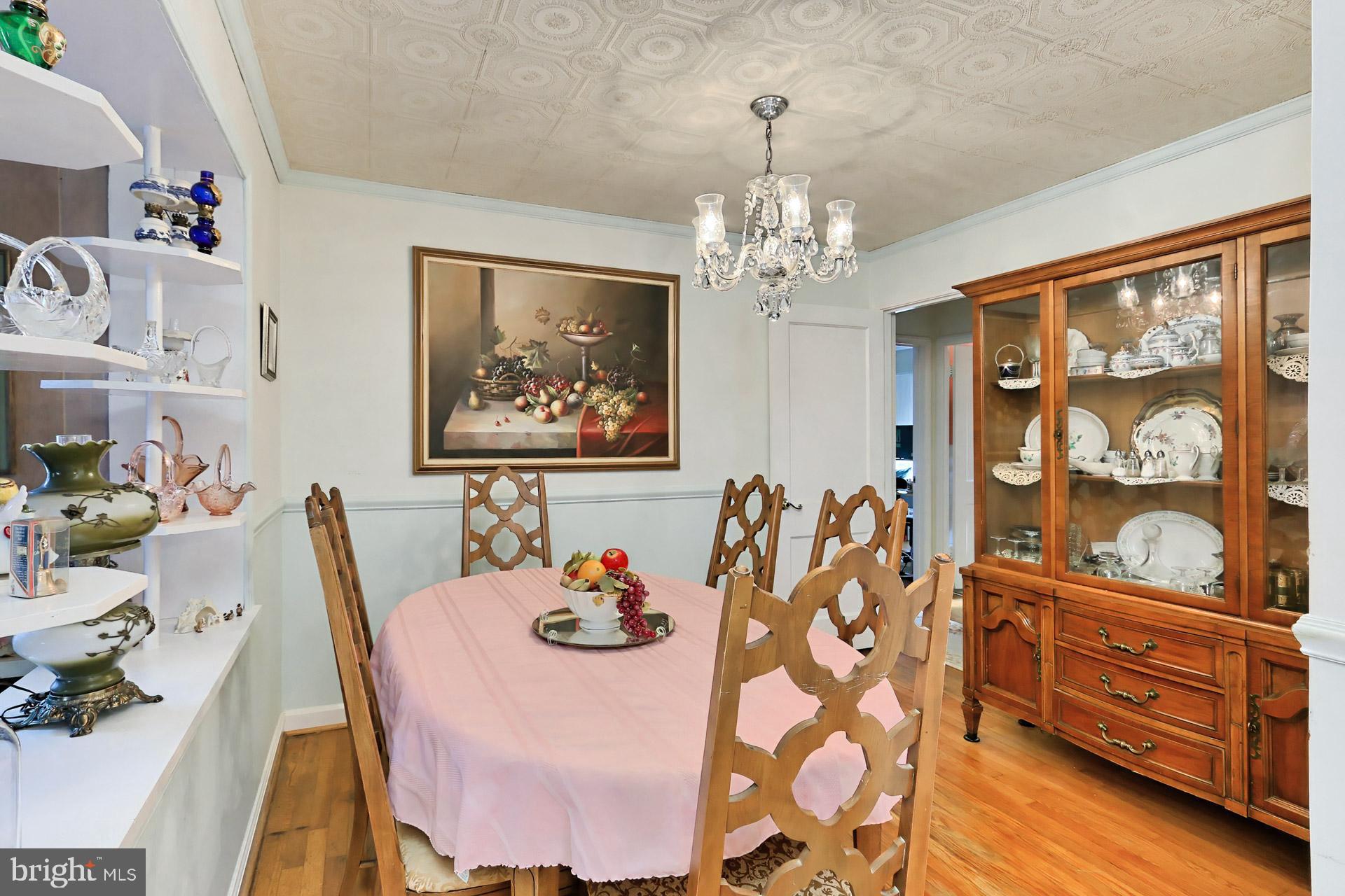 1806 Shenandoah Road Alexandria, VA 22308 - Photo 15 of 33 a view of a dining room with furniture a chandelier and wooden floor