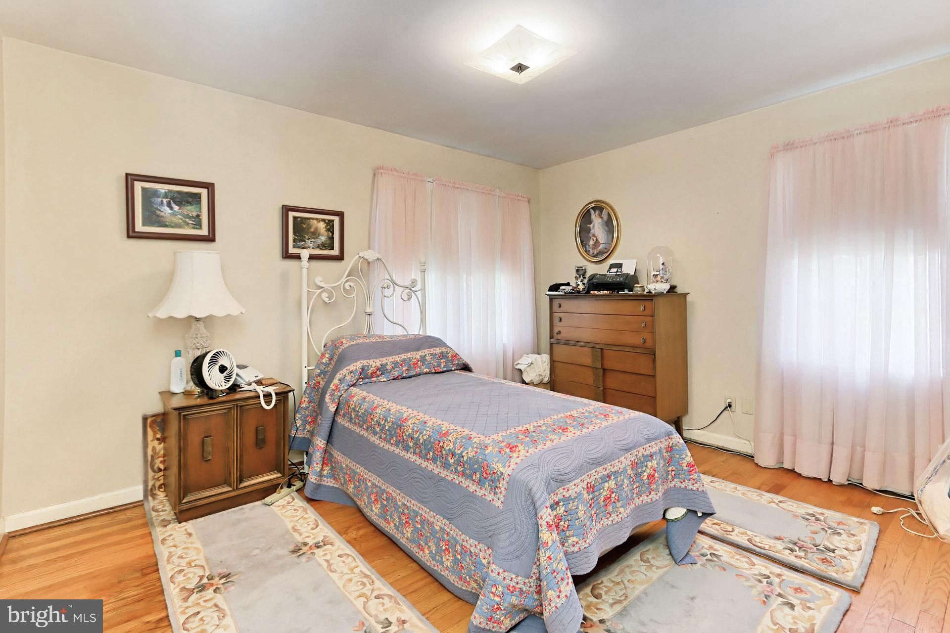 1806 Shenandoah Road Alexandria, VA 22308 - Photo 20 of 33 a bedroom with a bed and wooden floor