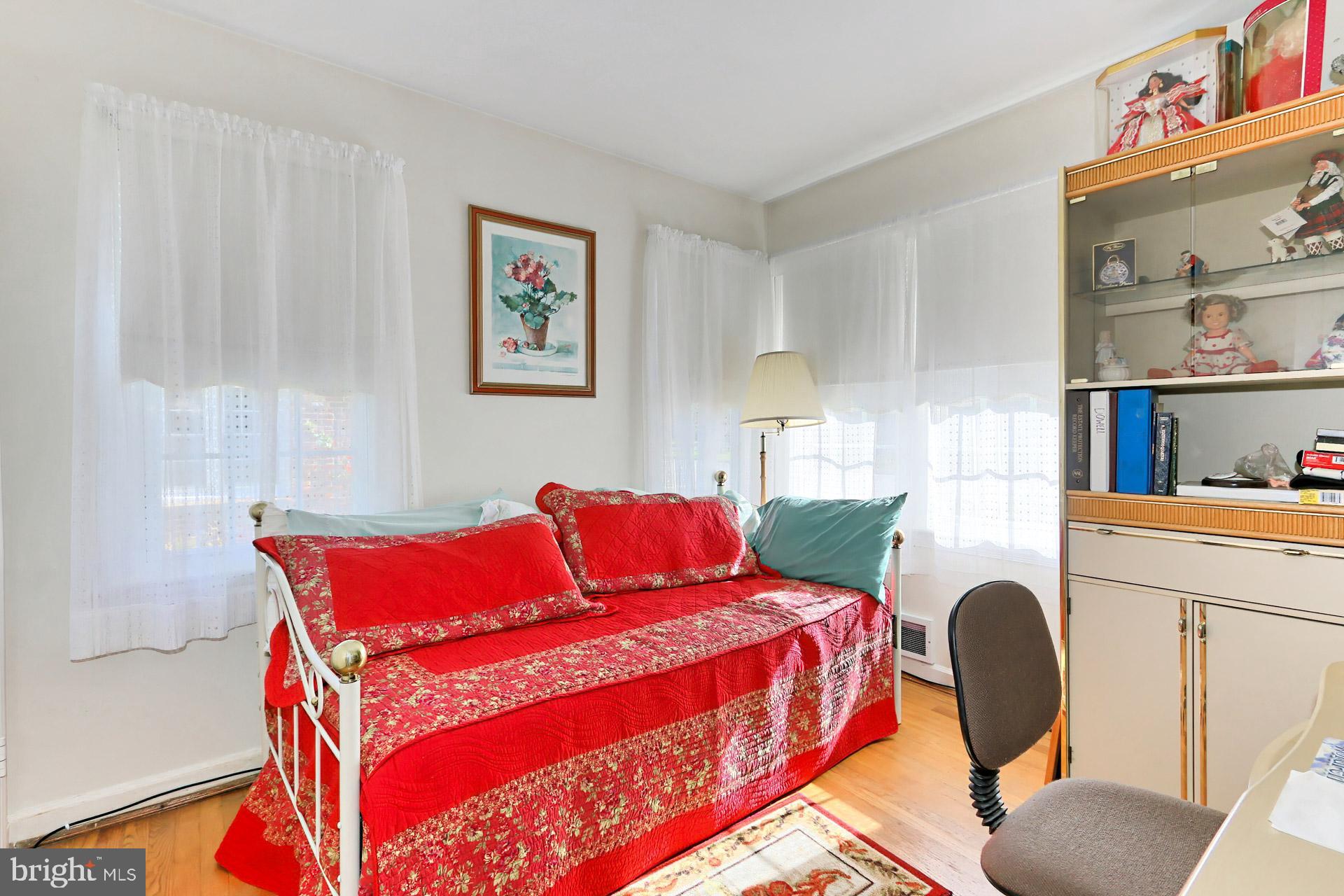 1806 Shenandoah Road Alexandria, VA 22308 - Photo 22 of 33 a bedroom with a bed and a chair with the bookshelf