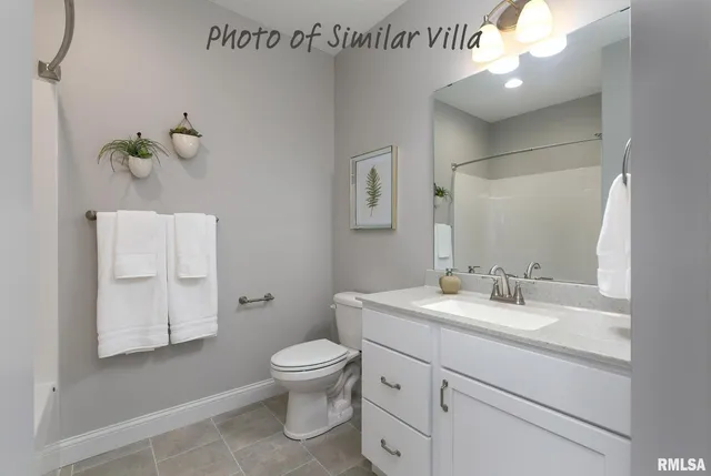 a bathroom with a granite countertop sink a toilet and bathtub