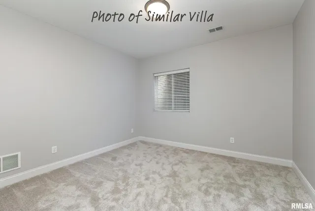 an empty room with closet area