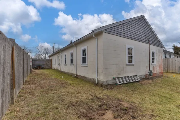 a view of a house with a backyard