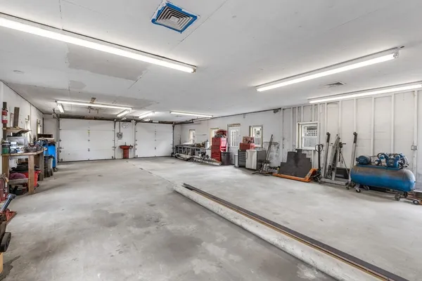 a view of a garage with rack and bicycle