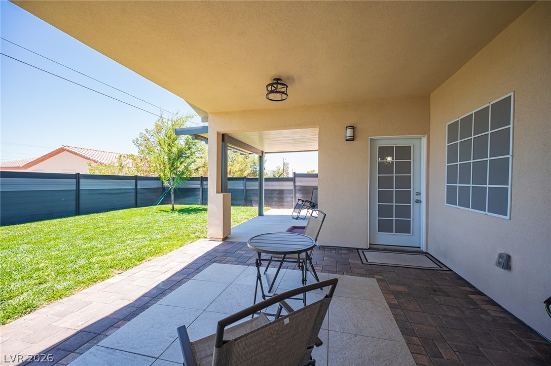 441 Belville Road Pahrump, NV 89048 - Photo 39 of 44 An inviting covered patio offers ample space for outdoor enjoyment, overlooking a manicured lawn.