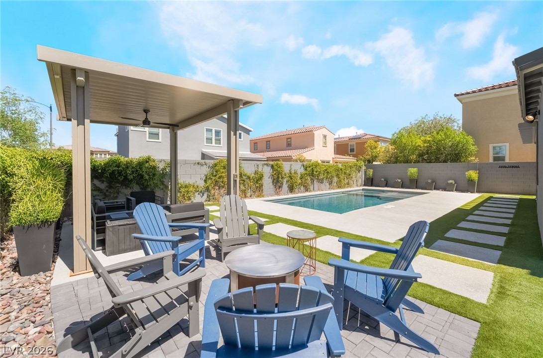 2166 Trivero Street Henderson, NV 89044 - Photo 37 of 61 An inviting backyard oasis features a shimmering pool alongside a covered patio for ultimate relaxation.