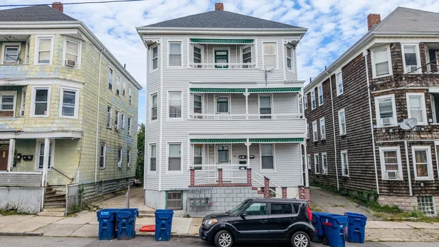 a car parked in front of a white building