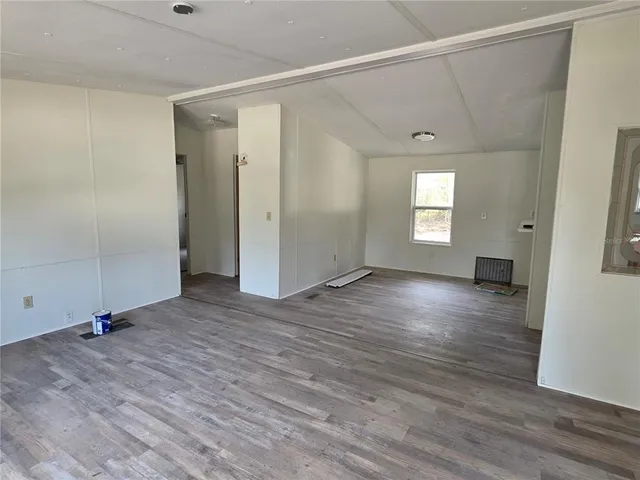 a view of a kitchen with wooden floor and a sink