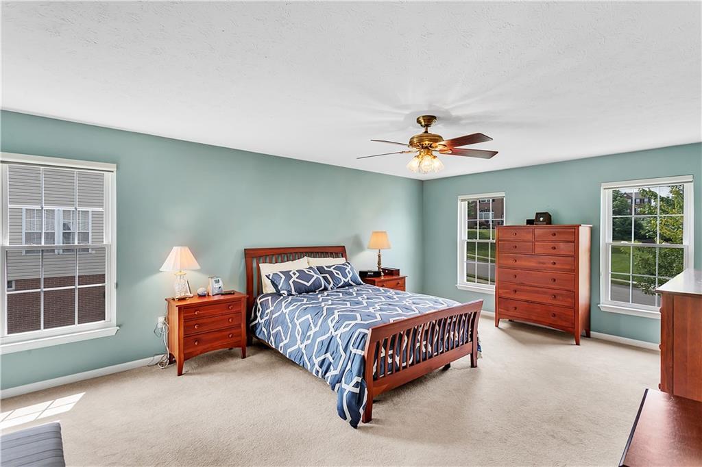229 Field Club Circle McKees Rocks, PA 15136 - Photo 16 of 34 a bedroom with a bed and a chandelier