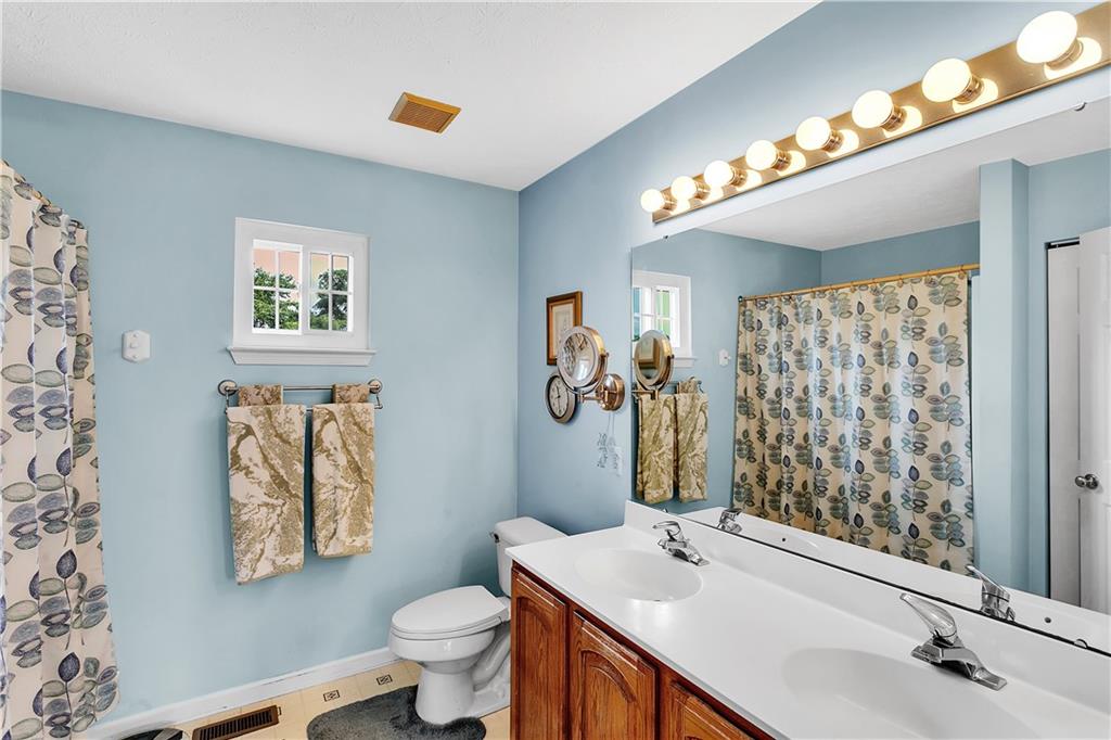 229 Field Club Circle McKees Rocks, PA 15136 - Photo 18 of 34 a bathroom with a sink a toilet a mirror and shower