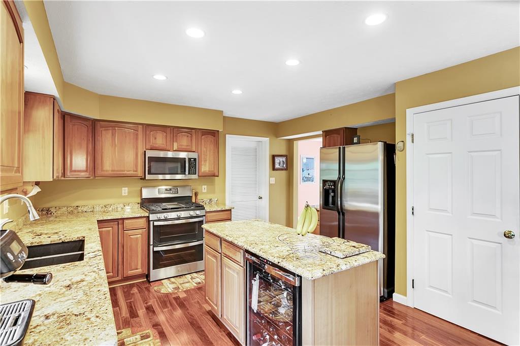 229 Field Club Circle McKees Rocks, PA 15136 - Photo 5 of 34 a kitchen with stainless steel appliances granite countertop a stove refrigerator and sink