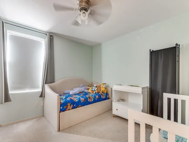 a bedroom with furniture and a window