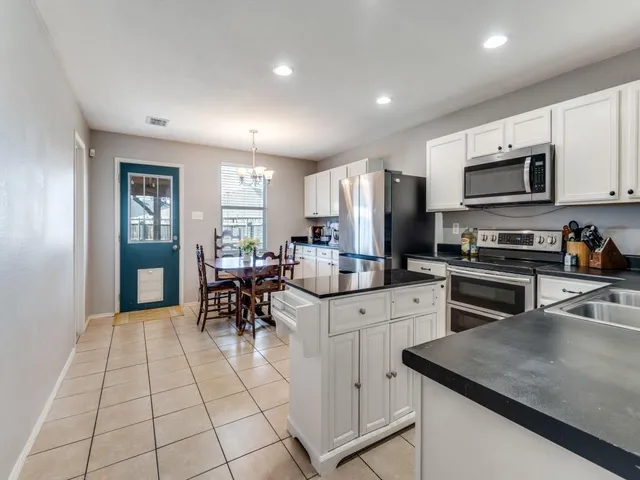 a kitchen with a sink cabinets and stainless steel appliances