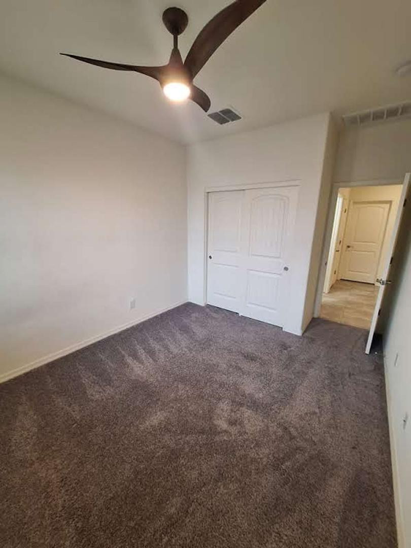 18541 West Mescal Street Surprise, AZ 85388 - Photo 14 of 31 an empty room with a empty space and a ceiling fan