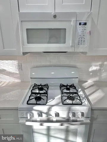 a kitchen with a stove and microwave