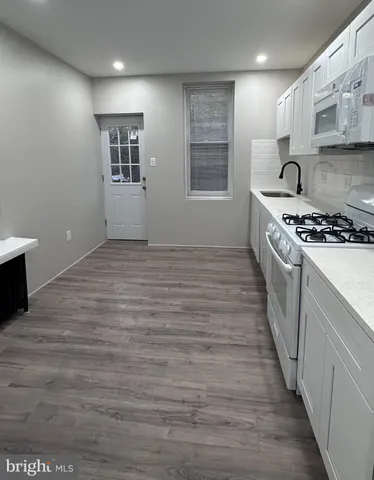 a kitchen with stainless steel appliances granite countertop a stove and a refrigerator