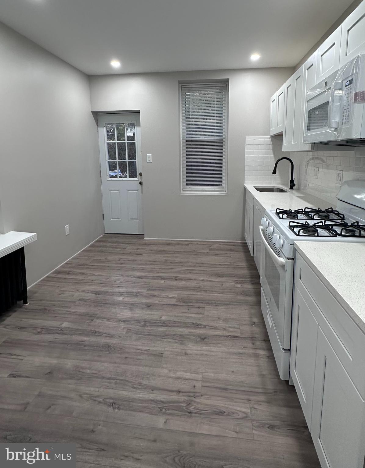 934 North Fallon Street Philadelphia, PA 19131 - Photo 13 of 26 a kitchen with stainless steel appliances granite countertop a stove and a refrigerator