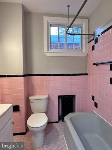 a bathroom with a toilet a sink and bathtub