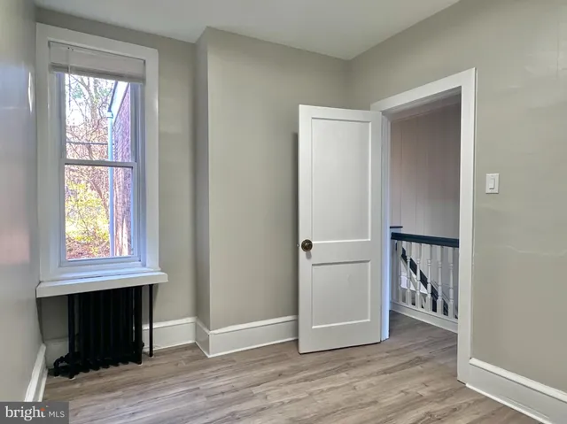 an entryway with a window and wooden floor