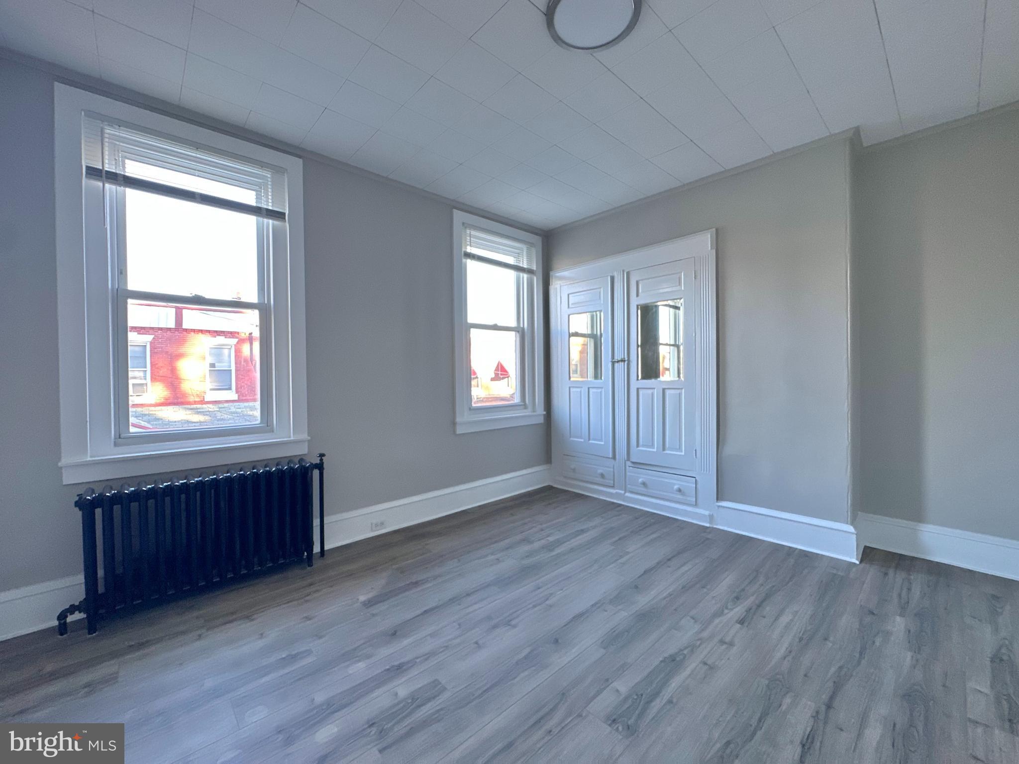 934 North Fallon Street Philadelphia, PA 19131 - Photo 23 of 26 an empty room with wooden floor and windows