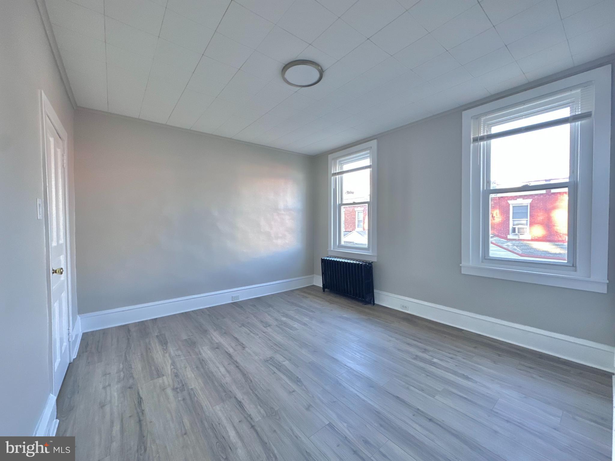 934 North Fallon Street Philadelphia, PA 19131 - Photo 25 of 26 an empty room with wooden floor and windows