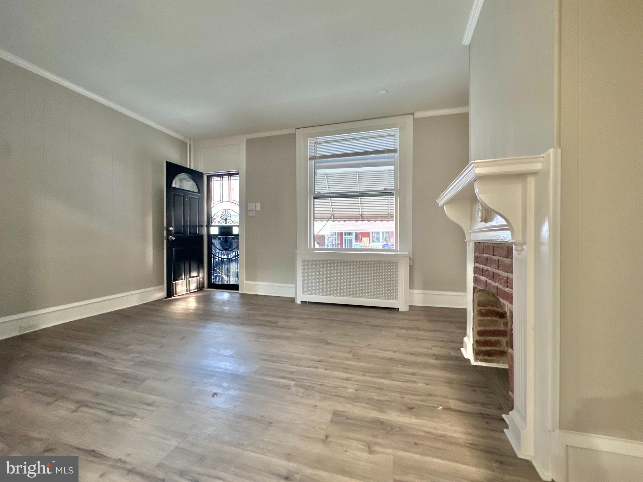 934 North Fallon Street Philadelphia, PA 19131 - Photo 5 of 26 wooden floor in an empty room with a window
