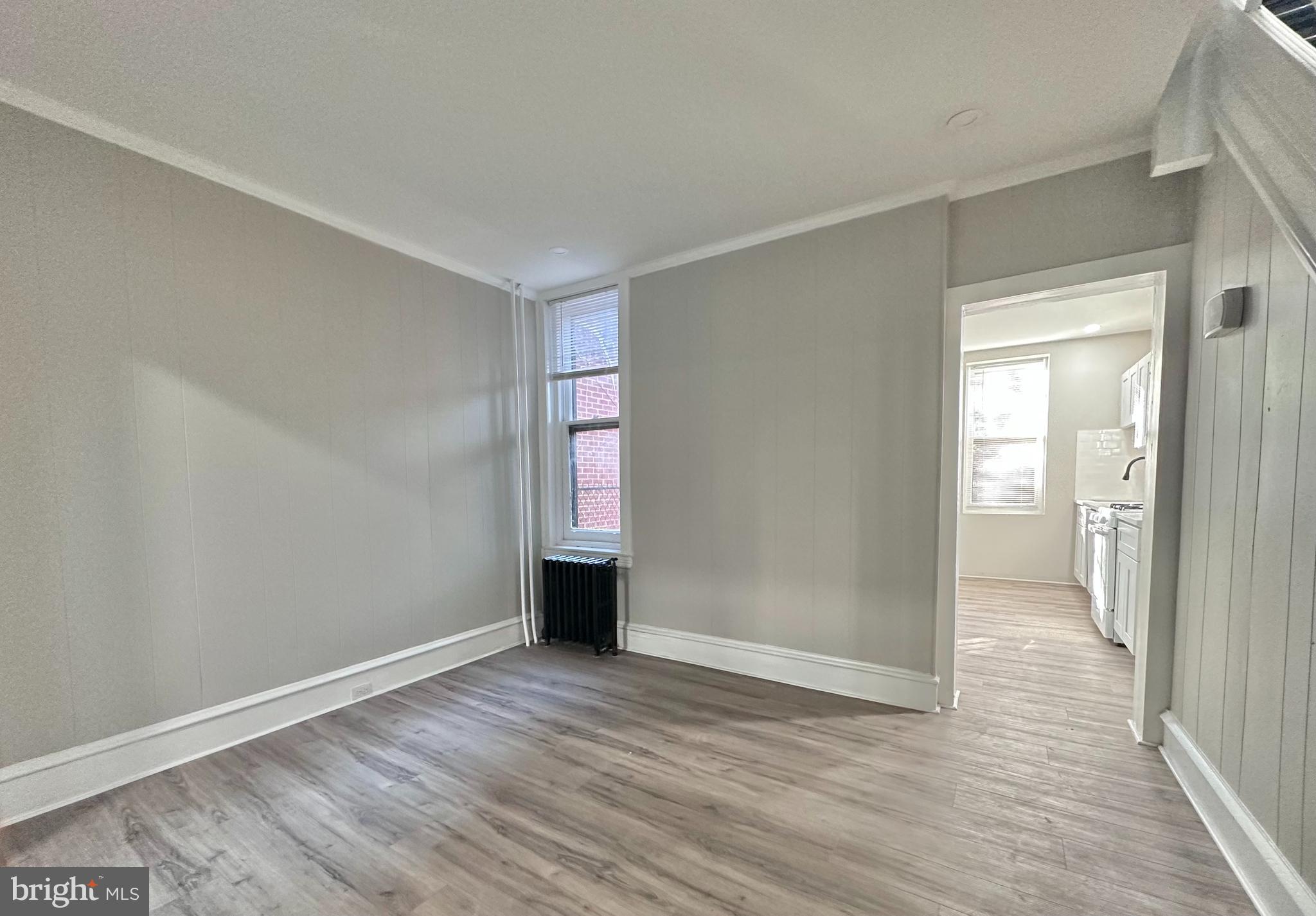 934 North Fallon Street Philadelphia, PA 19131 - Photo 8 of 26 a view of an empty room with wooden floor and a window