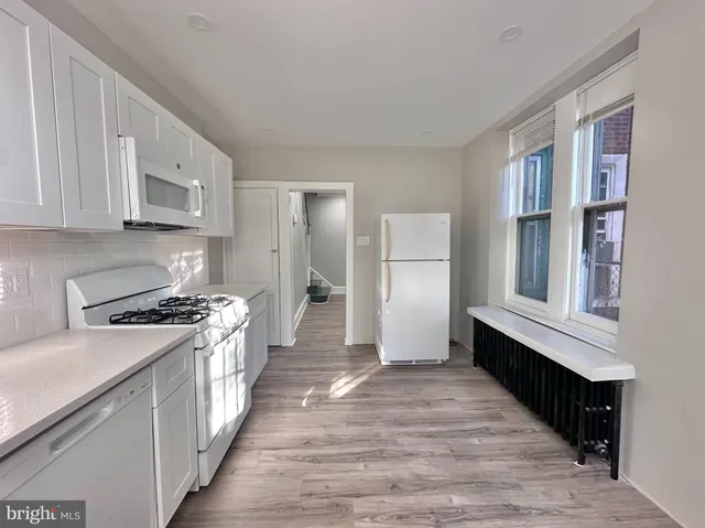 a kitchen with stainless steel appliances granite countertop a stove a refrigerator and cabinets