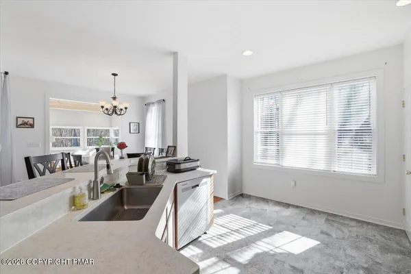 a living room with furniture potted plant and a window