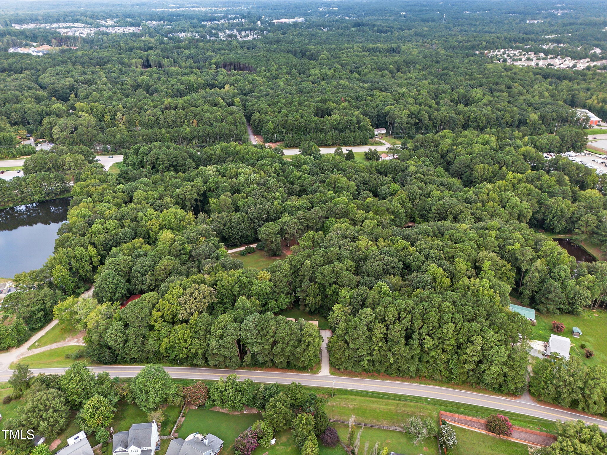 709 Oak Ridge Drive Cary, NC 27519 - Photo 11 of 30 a view of a green field with lots of bushes