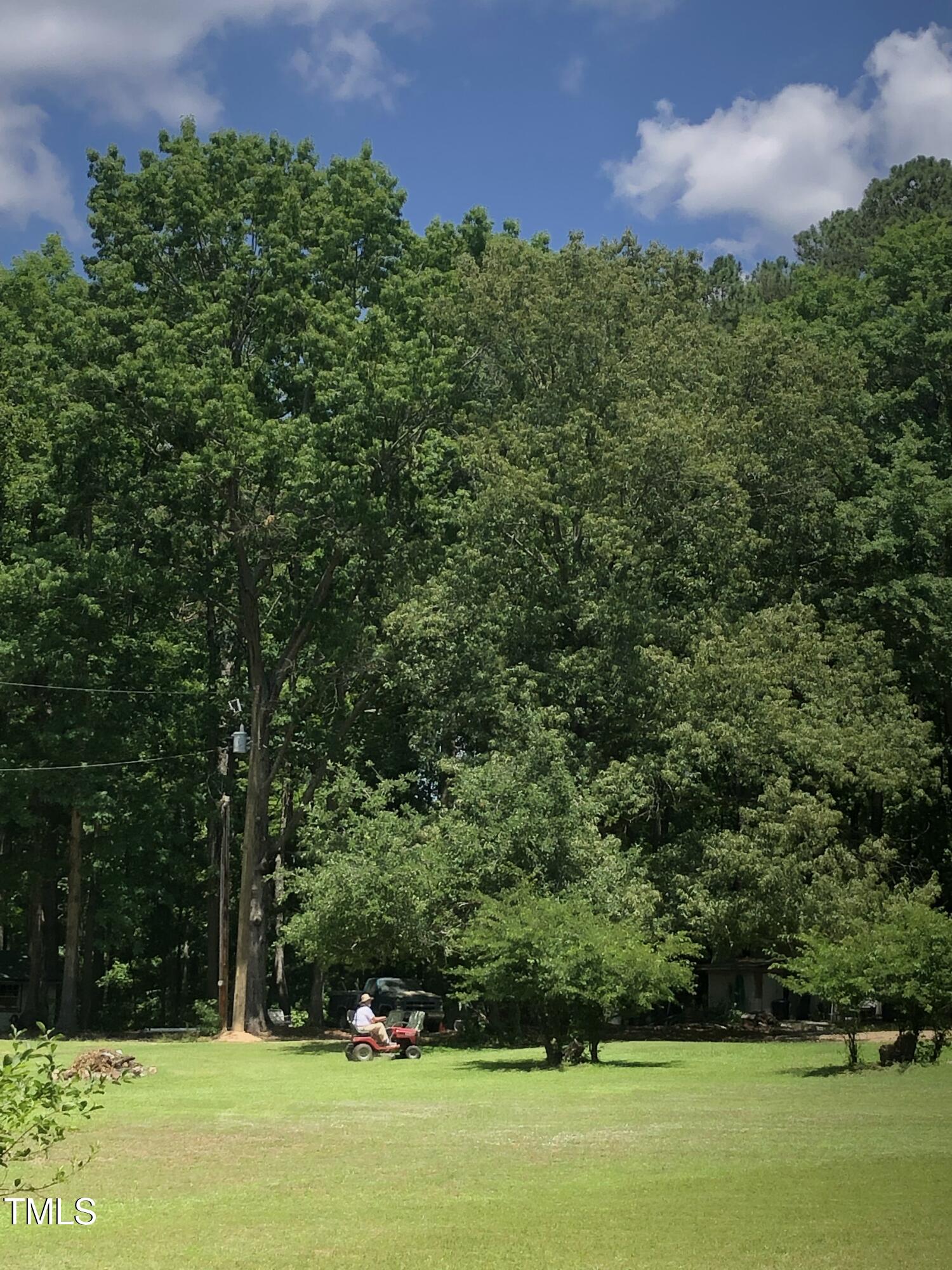 709 Oak Ridge Drive Cary, NC 27519 - Photo 22 of 30 a view of a green field with wooden fence