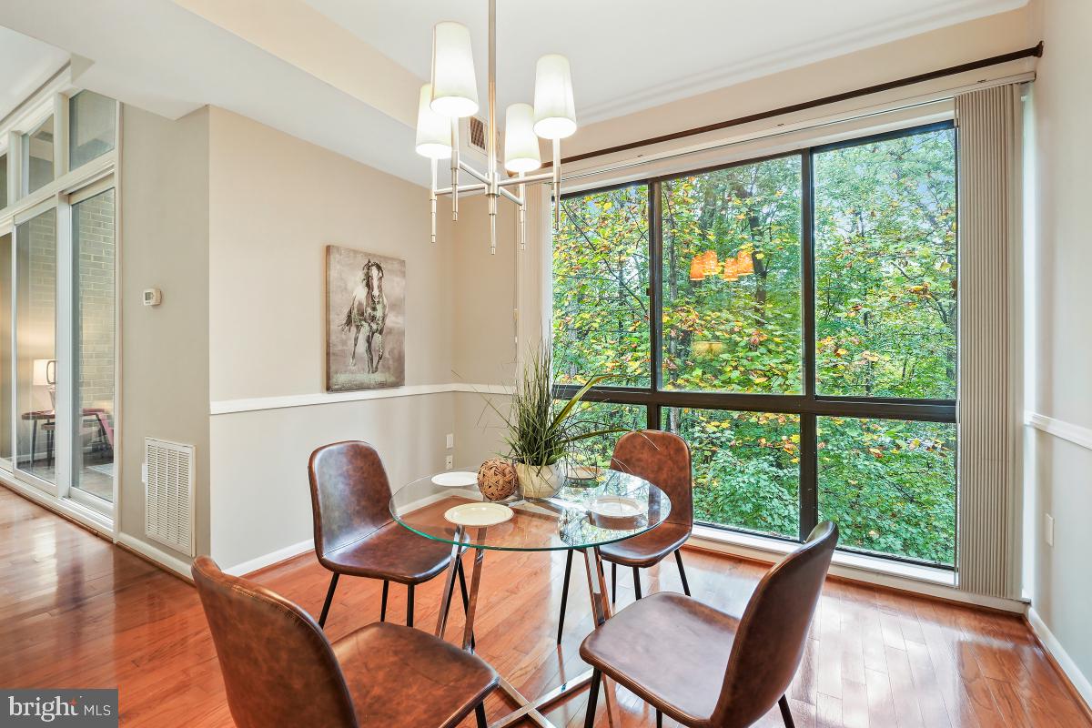2102 Green Watch Way, Unit 301 Reston, VA 20191 - Photo 13 of 32 a view of a dining room with furniture window and wooden floor