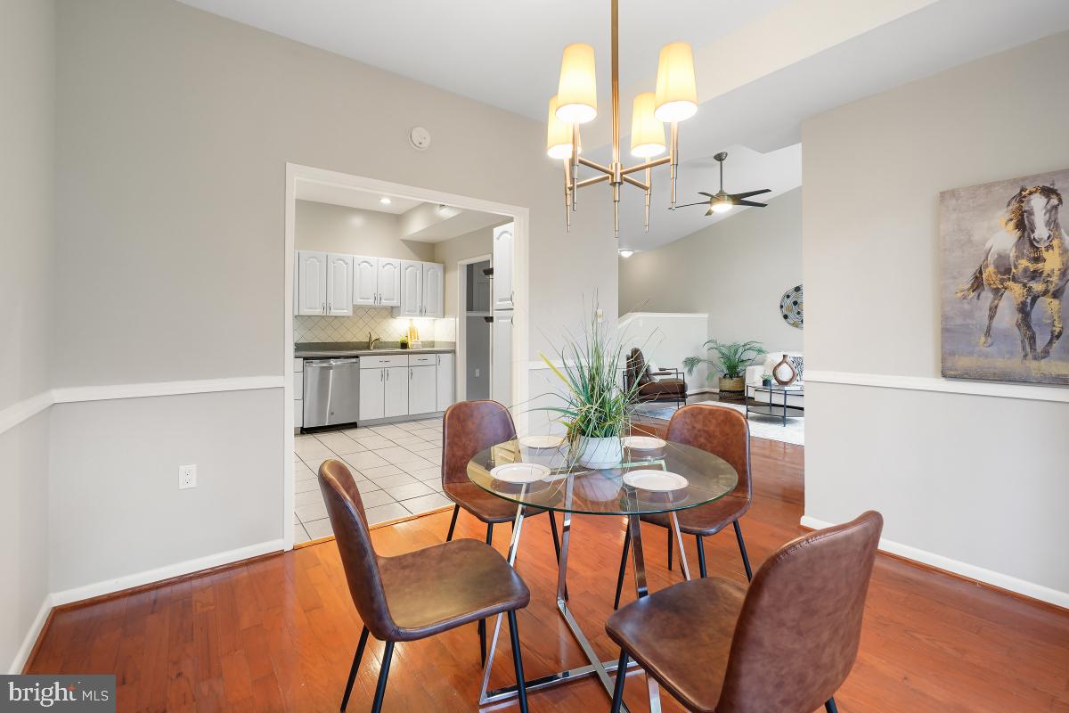 2102 Green Watch Way, Unit 301 Reston, VA 20191 - Photo 14 of 32 a view of a dining room with furniture and chandelier