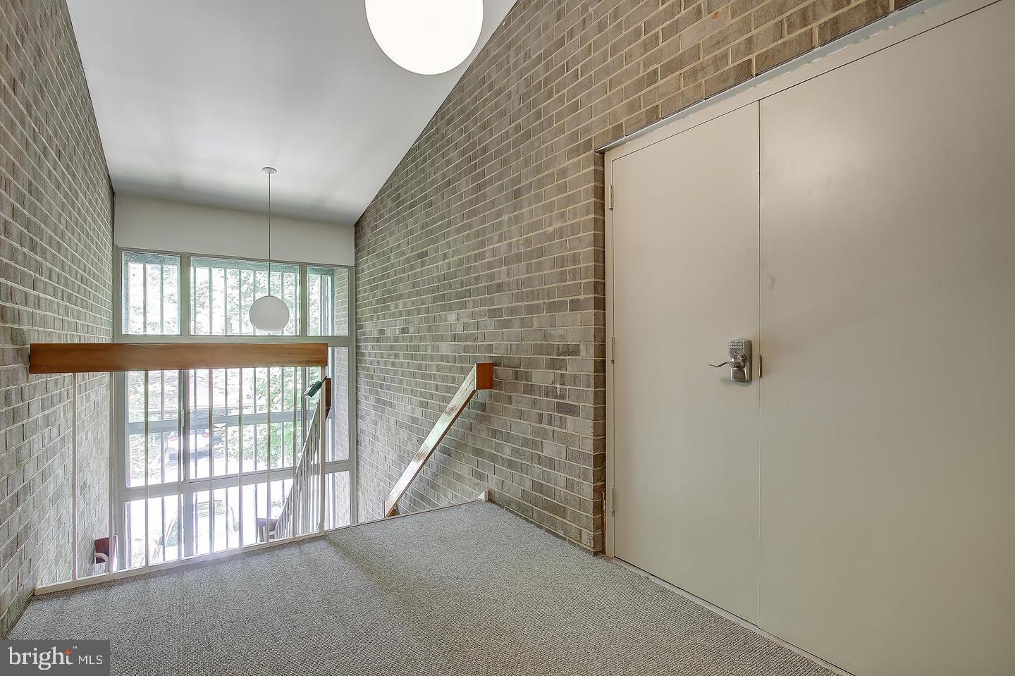 2102 Green Watch Way, Unit 301 Reston, VA 20191 - Photo 2 of 32 a view of a hallway with windows