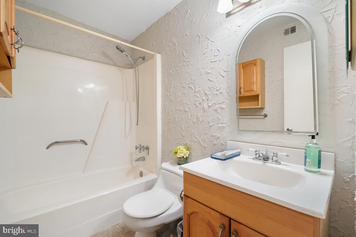 2102 Green Watch Way, Unit 301 Reston, VA 20191 - Photo 21 of 32 a bathroom with a sink toilet and shower